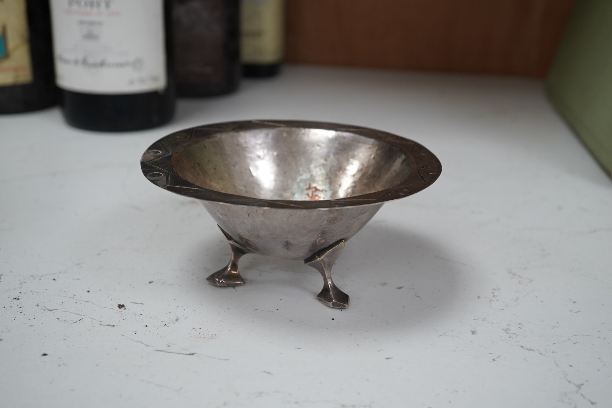 Two Nuremberg style embossed brass alms dishes and a Dresser style silver plated three footed bowl, brass dishes 36cm diameter. Condition - good